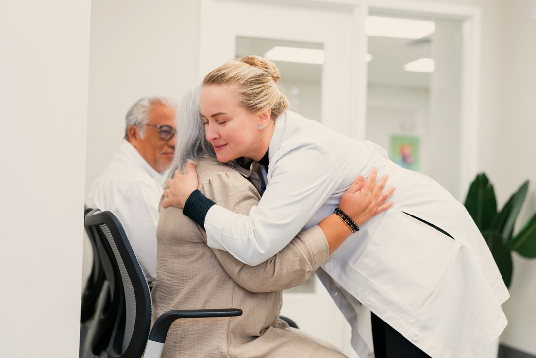 Dr. Olga Kromo hugs a patient.